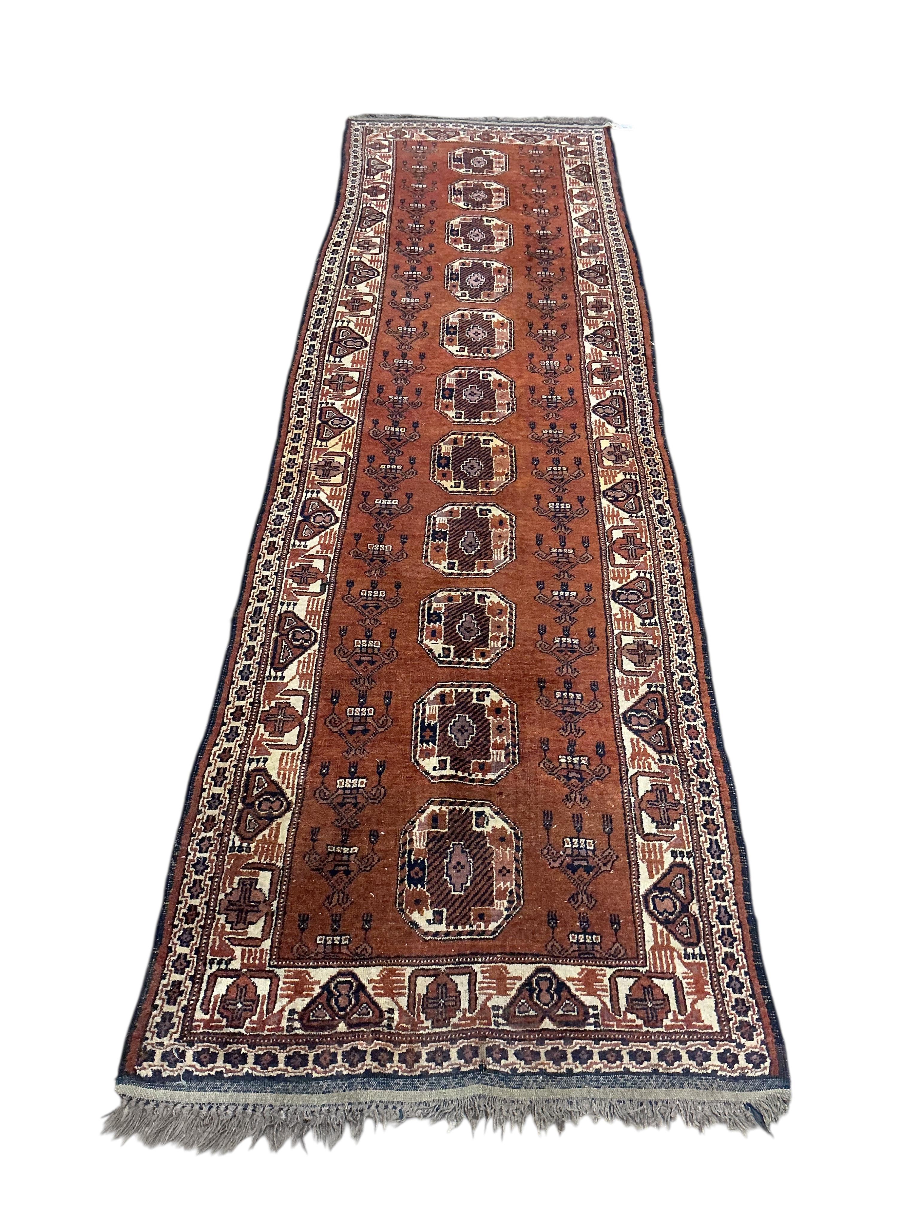 An Afghan red ground runner, 300 x 82cm and a rug, (worn)